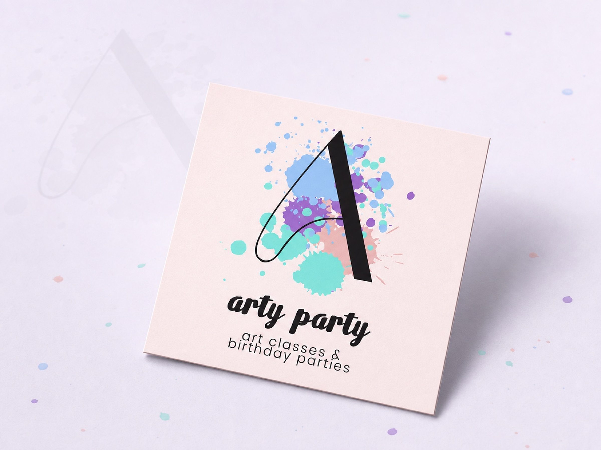 The business card's front — mark, wordmark, and the tagline underneath: "art classes & birthday parties."