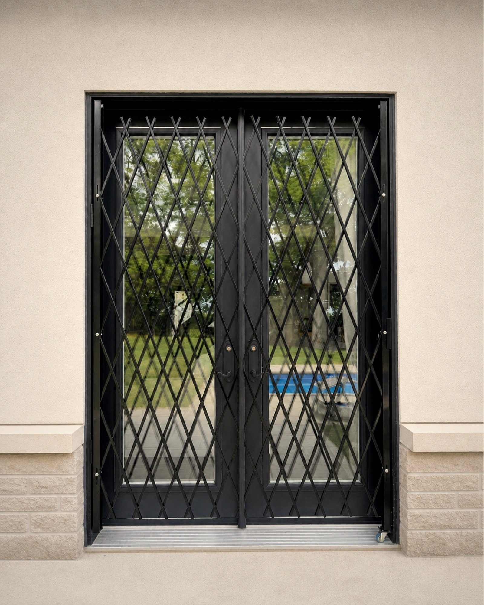 Paired French doors, each leaf gated to match the other exactly.