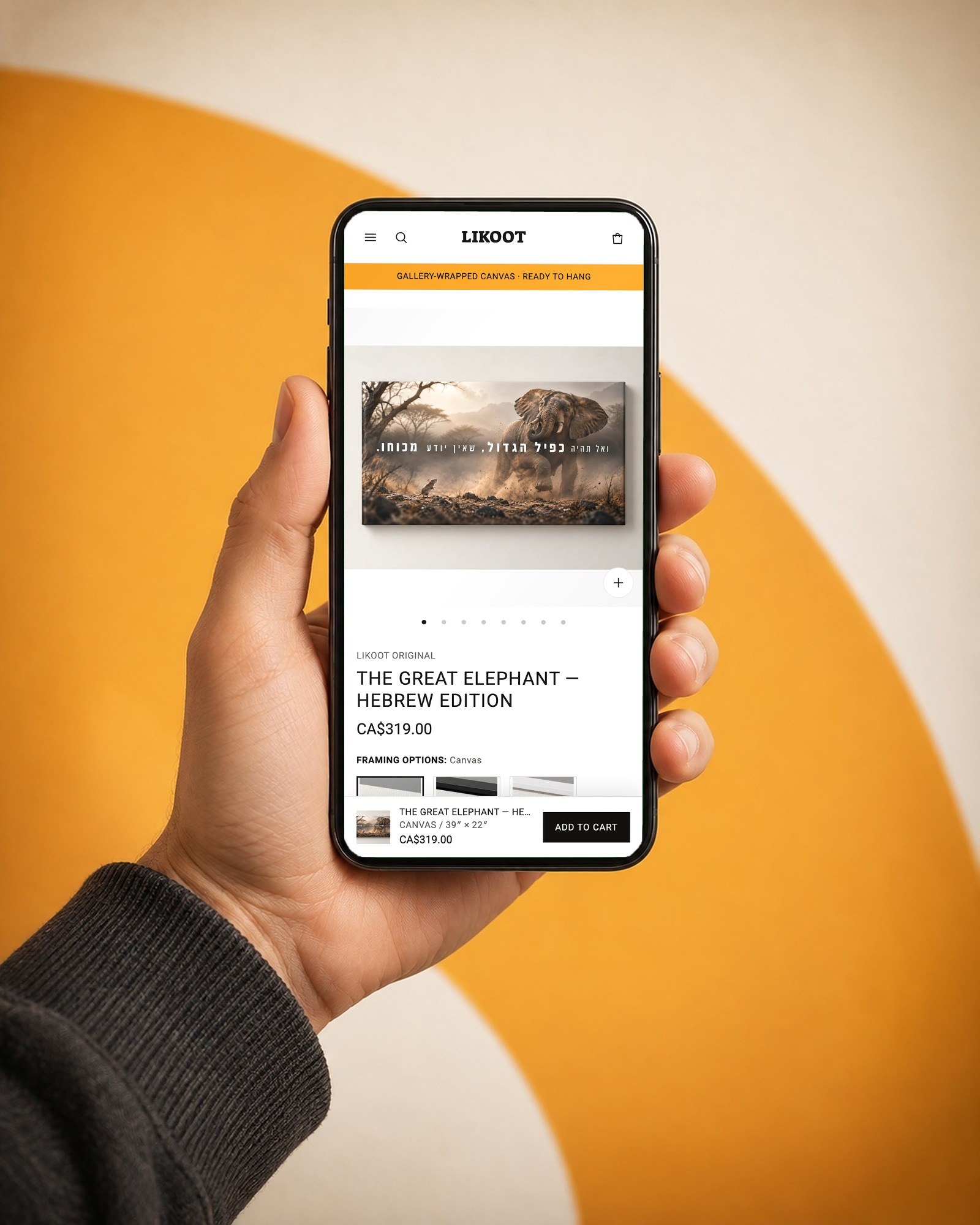 The Great Elephant artwork page on a phone, held against a saffron arc.