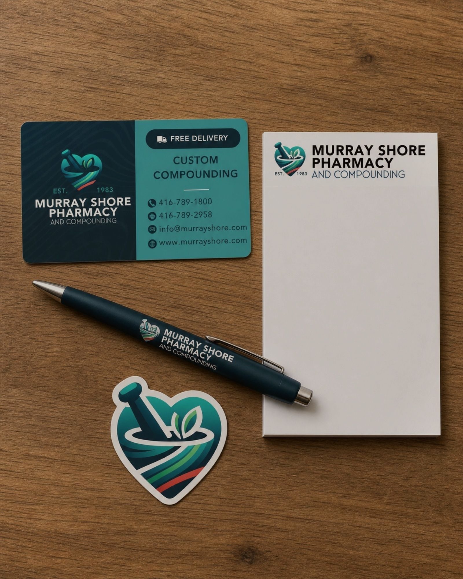 The small stuff that adds up — gift cards, notepads, a pen worth keeping, all carrying the same mark.